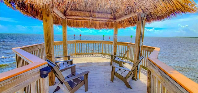 a view of an outdoor sitting area with wooden fence