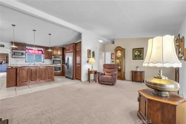 a kitchen with stainless steel appliances granite countertop a refrigerator a oven and a sink