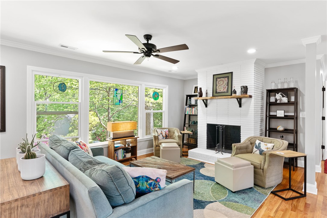 209 Manley Drive Clemson, SC 29631 - Photo 12 of 44 This bright living room boasts a cozy fireplace and expansive windows.