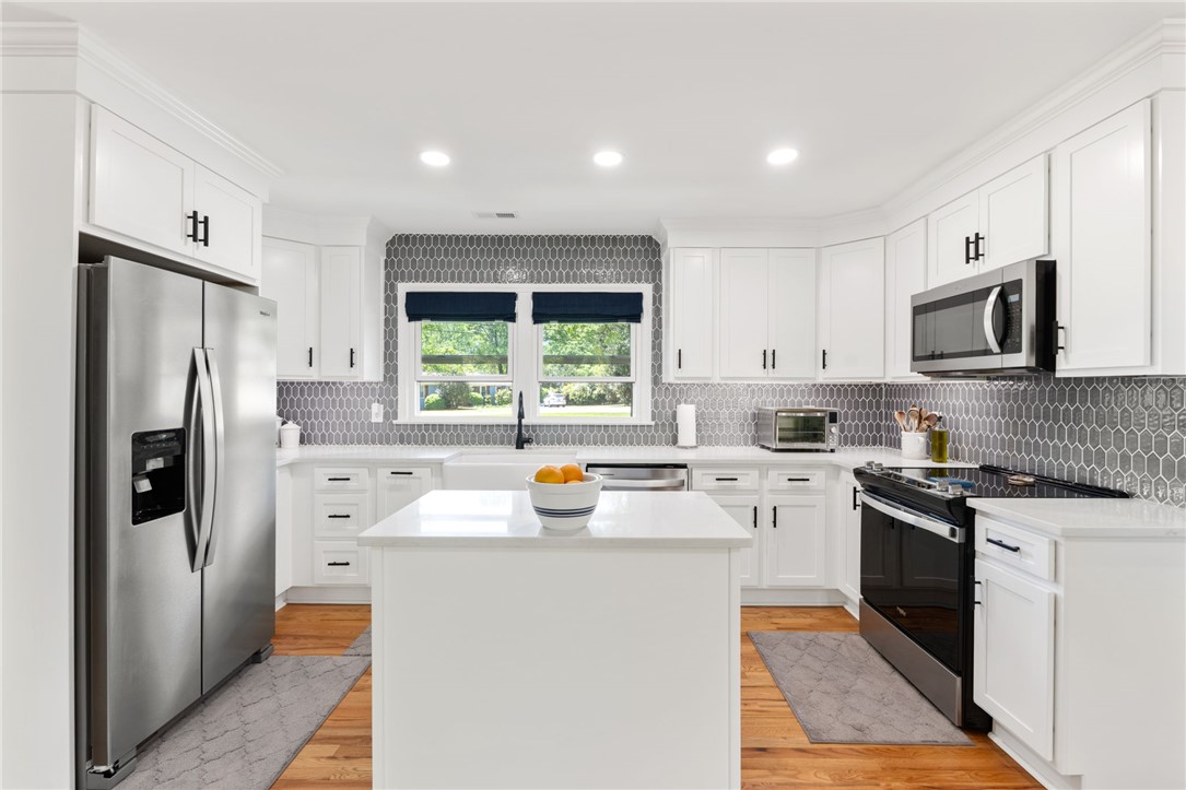 209 Manley Drive Clemson, SC 29631 - Photo 16 of 44 This bright kitchen features a functional island and gleaming stainless steel appliances.