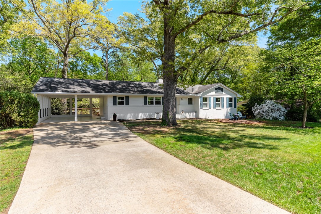 209 Manley Drive Clemson, SC 29631 - Photo 3 of 44 This charming home offers a spacious driveway and a delightful front yard surrounded by mature trees.