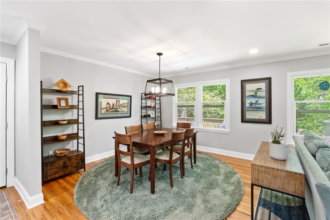209 Manley Drive Clemson, SC 29631 - Photo 7 of 44 This bright dining room features rich hardwood flooring, crown molding, and large windows with abundant natural light.