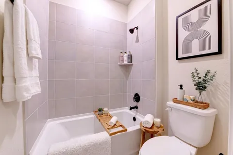 a bath room with a toilet and a shower curtain