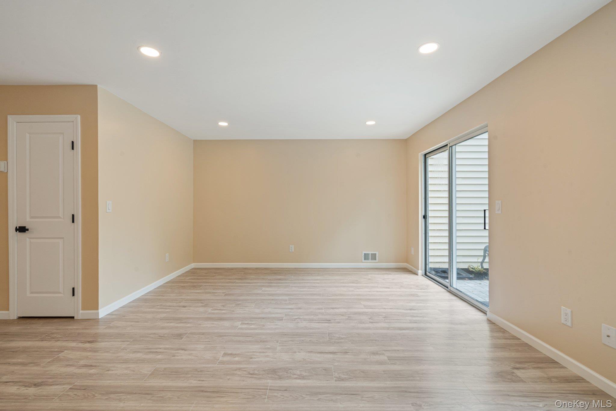 6 Doe Path Coram, NY 11727 - Photo 12 of 48 Unfurnished room featuring plenty of natural light, light wood finished floors, and recessed lighting