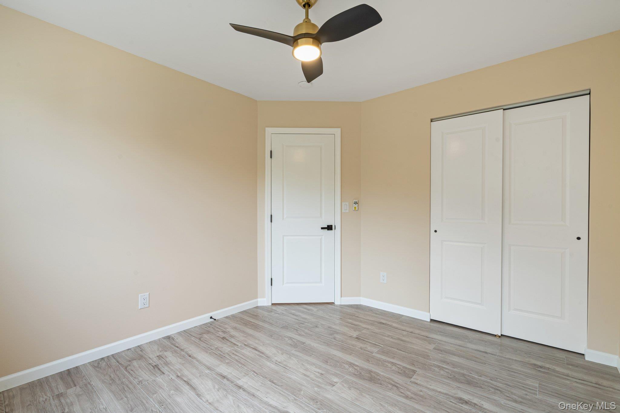6 Doe Path Coram, NY 11727 - Photo 14 of 48 Unfurnished bedroom featuring light wood-type flooring, a closet, and a ceiling fan