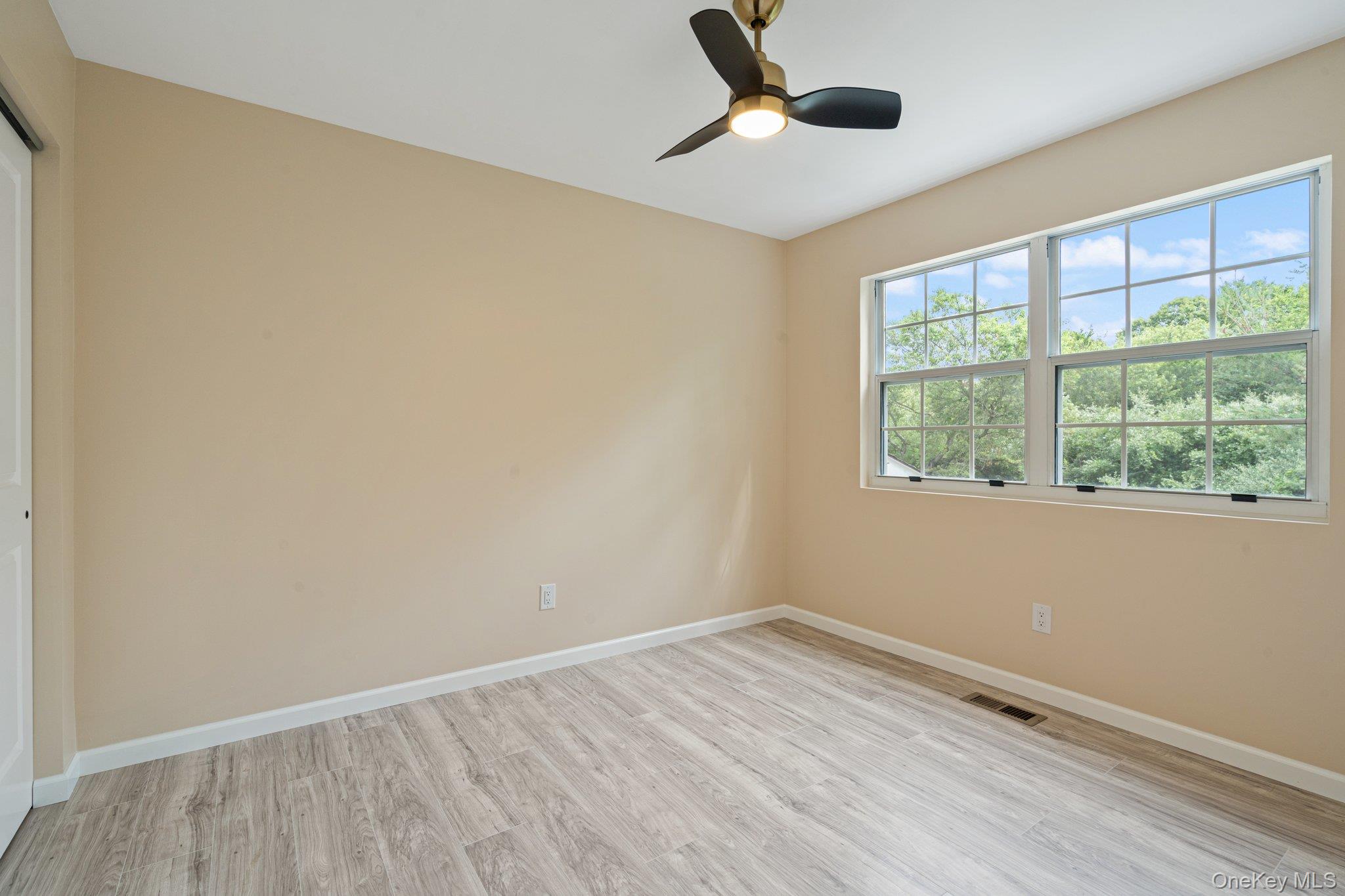 6 Doe Path Coram, NY 11727 - Photo 17 of 48 Empty room with light wood-style flooring and ceiling fan