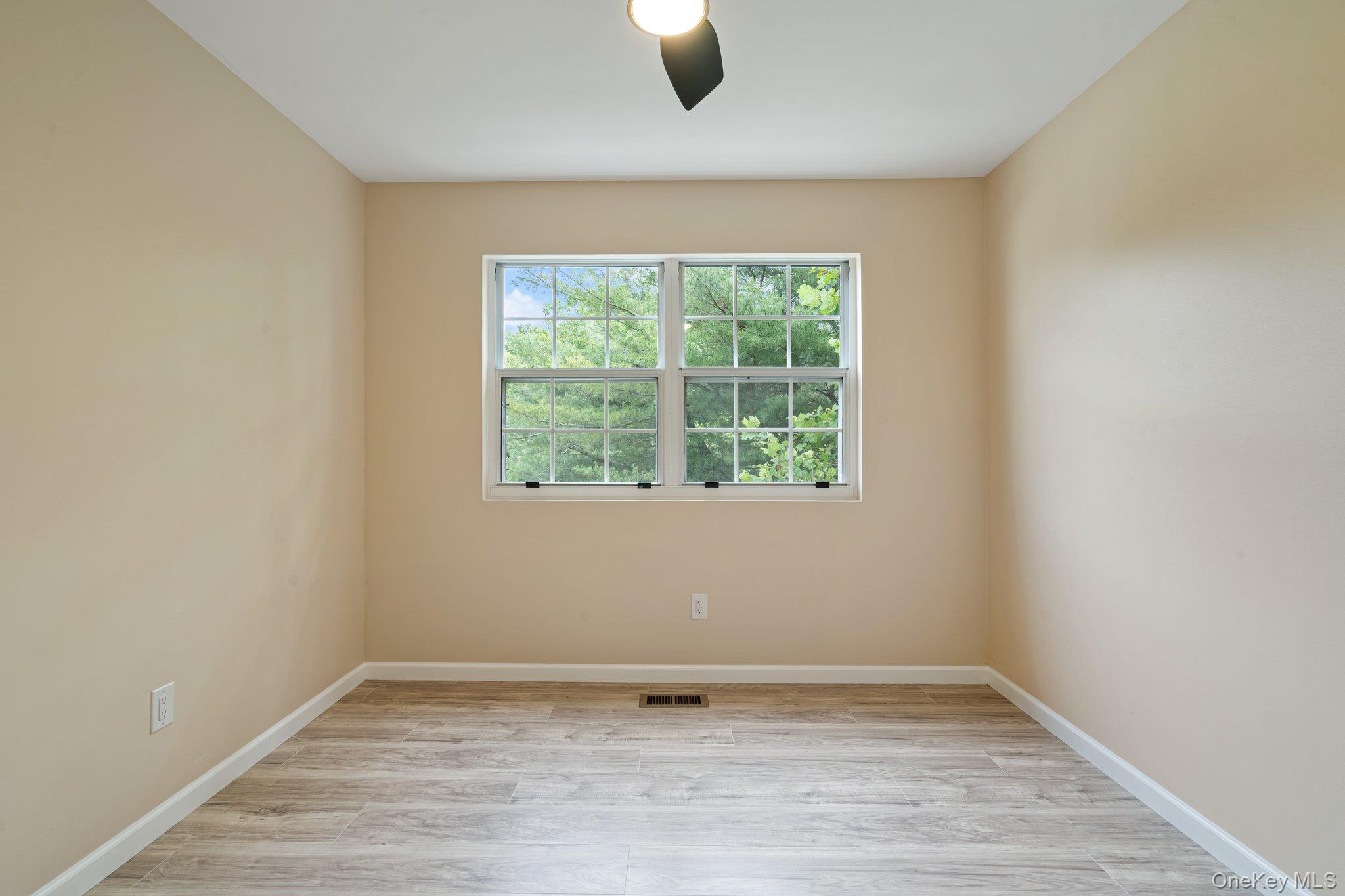 6 Doe Path Coram, NY 11727 - Photo 19 of 48 Unfurnished room featuring light wood-type flooring and a ceiling fan