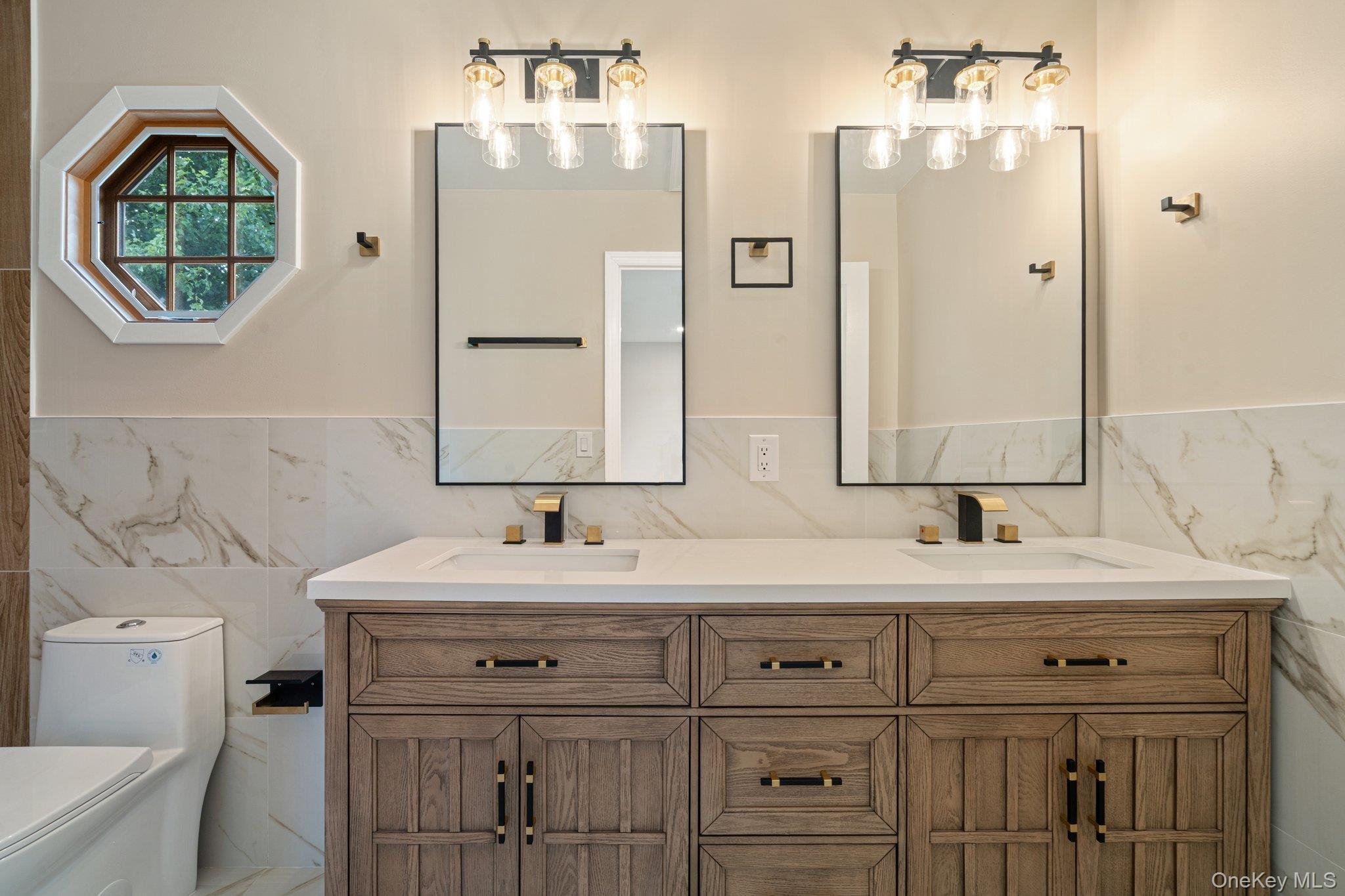 6 Doe Path Coram, NY 11727 - Photo 24 of 48 Bathroom featuring tile walls, double vanity, and wainscoting