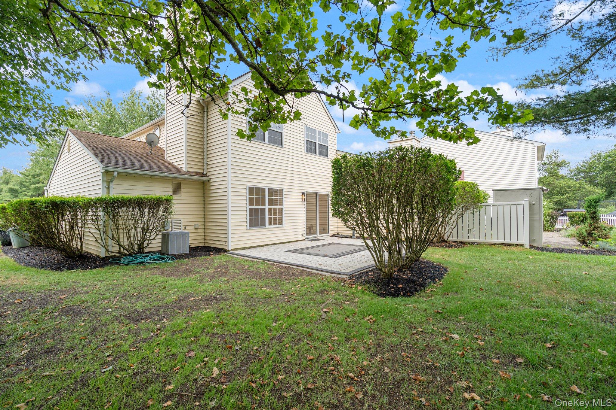 6 Doe Path Coram, NY 11727 - Photo 29 of 48 Rear view of house with a patio
