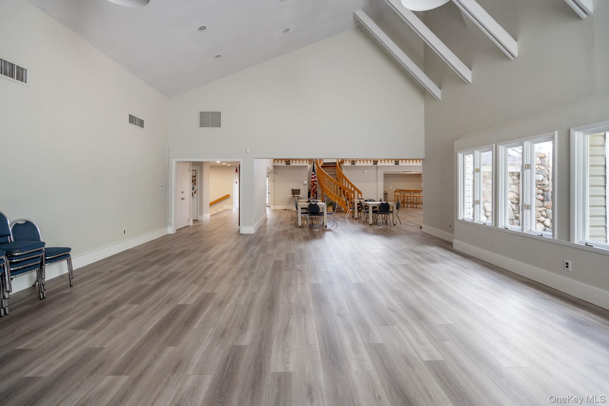 6 Doe Path Coram, NY 11727 - Photo 44 of 48 Living area featuring high vaulted ceiling, stairs, and wood finished floors