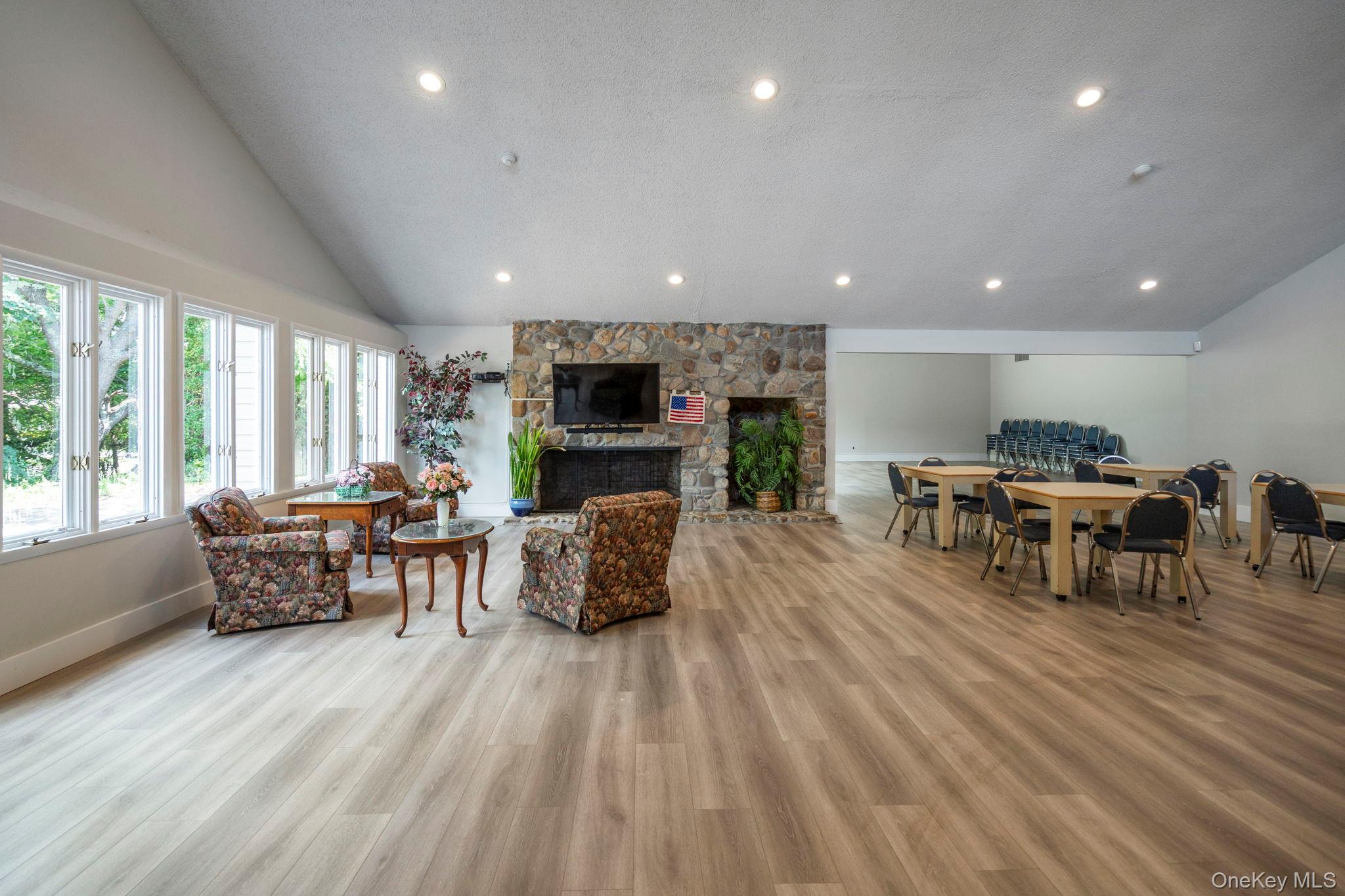 6 Doe Path Coram, NY 11727 - Photo 45 of 48 Living room with a fireplace, recessed lighting, light wood-style floors, and high vaulted ceiling