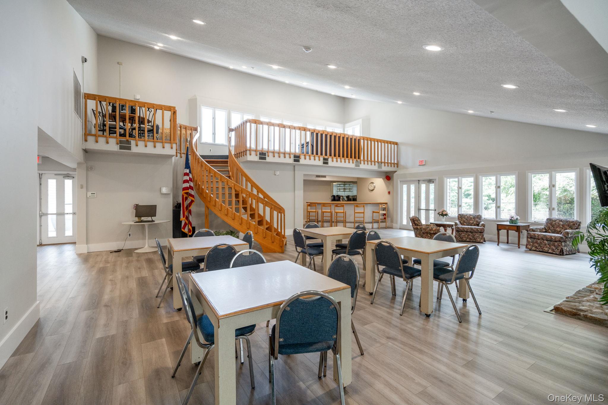 6 Doe Path Coram, NY 11727 - Photo 46 of 48 Dining space with high vaulted ceiling, recessed lighting, stairs, wood finished floors, and a textured ceiling
