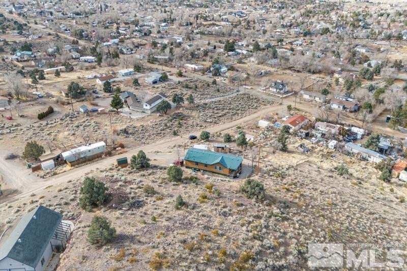 15085 Westwind Circle Reno, NV 89521 - Photo 25 of 28 a backyard of a house with a yard and covered with trees