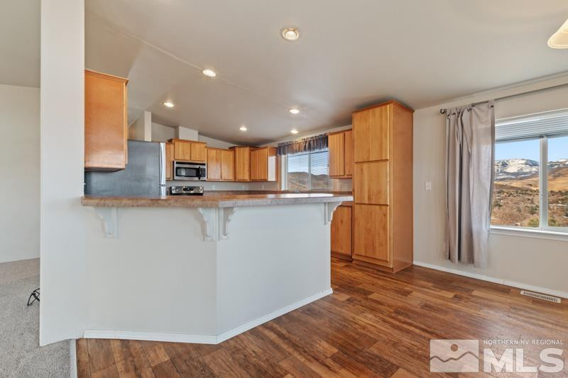 15085 Westwind Circle Reno, NV 89521 - Photo 6 of 28 a kitchen with stainless steel appliances granite countertop a refrigerator a sink and a stove top oven