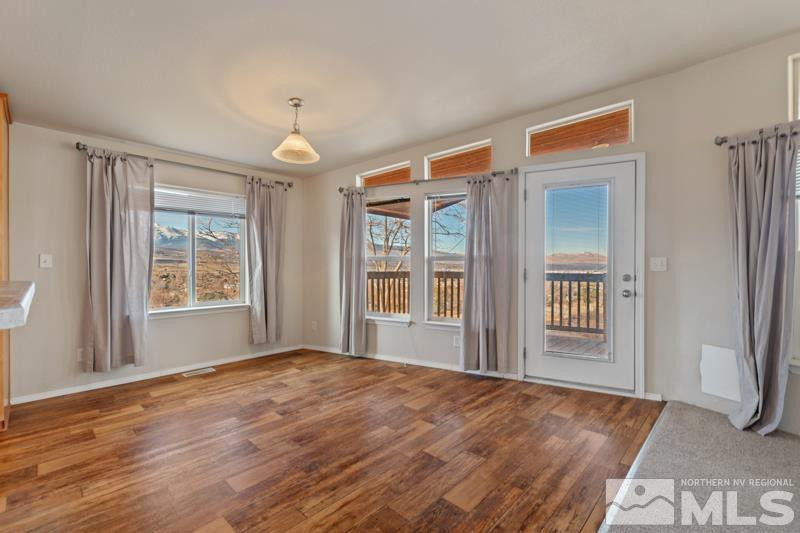 15085 Westwind Circle Reno, NV 89521 - Photo 7 of 28 a view of an empty room with glass door and windows