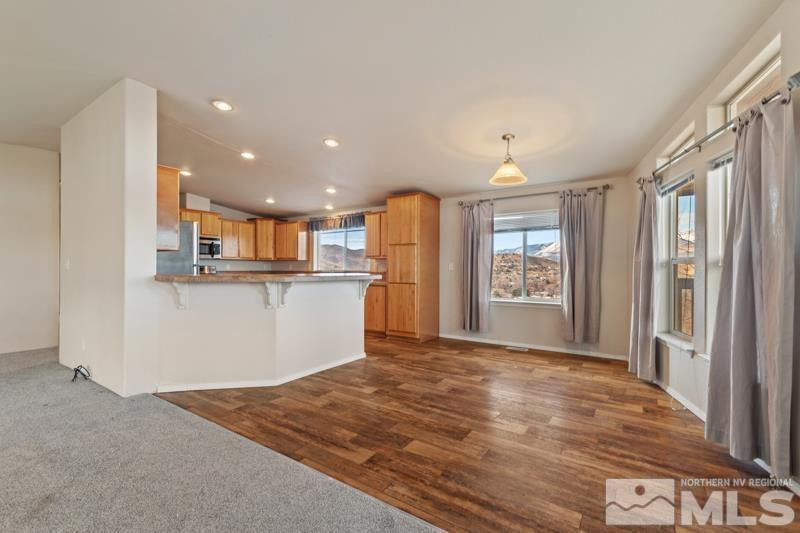 15085 Westwind Circle Reno, NV 89521 - Photo 8 of 28 a view of a kitchen with kitchen island wooden floors appliances and counter space