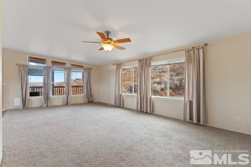 15085 Westwind Circle Reno, NV 89521 - Photo 10 of 28 a view of an empty room with a window and a kitchen