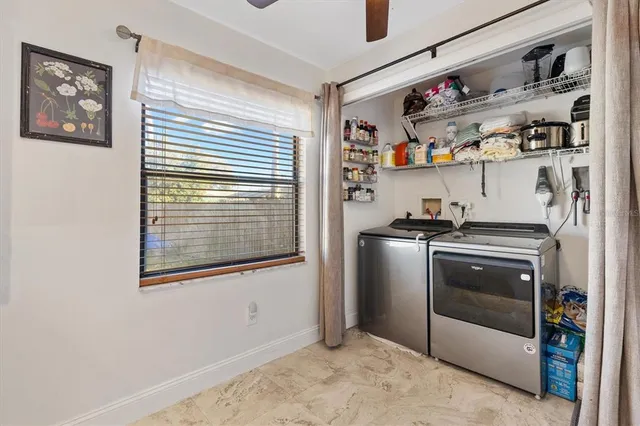 a kitchen with stainless steel appliances granite countertop a refrigerator and a window