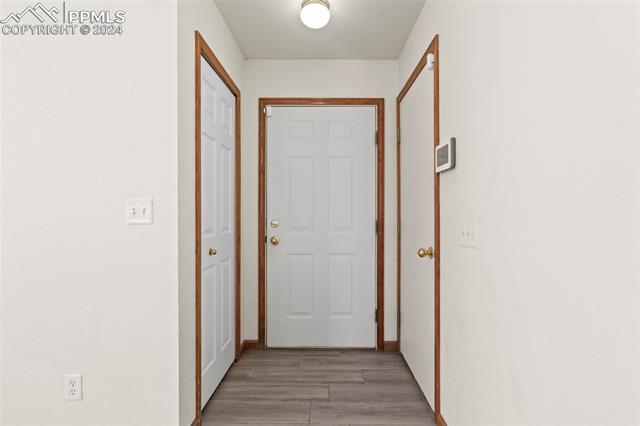 4763 Brant Road Colorado Springs, CO 80911 - Photo 3 of 26 Hallway featuring light hardwood / wood-style floors
