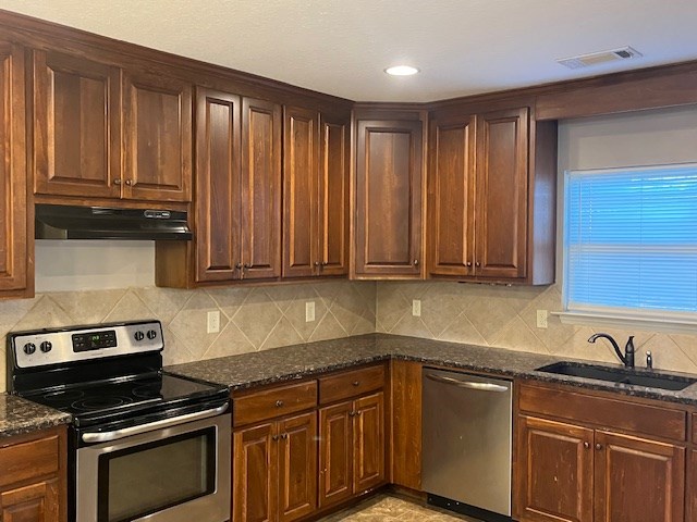 6 Summershade Court Fort Mitchell, AL 36856 - Photo 5 of 12 a kitchen with granite countertop a stove a sink dishwasher and cabinets