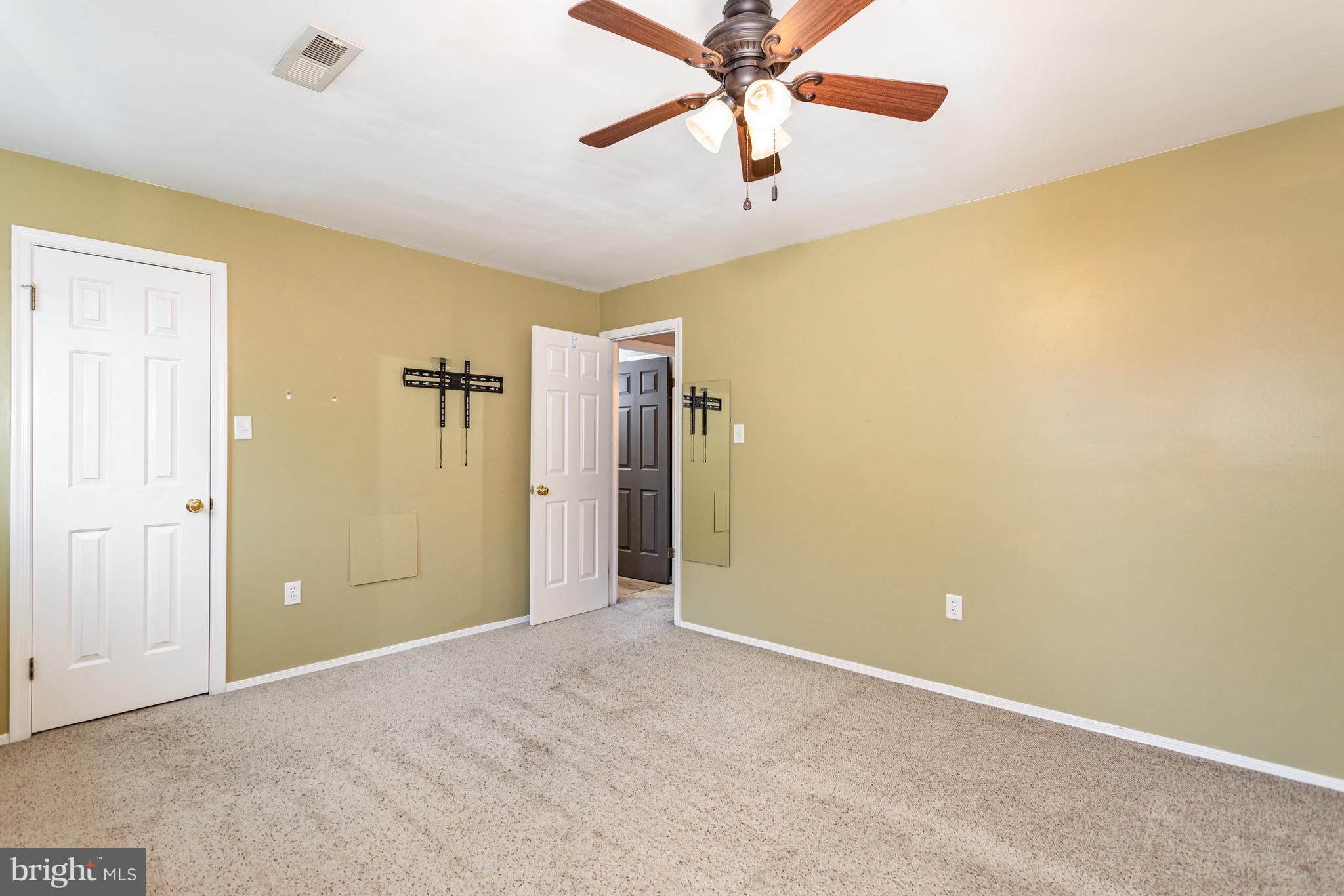 17 Mall Road Etters, PA 17319 - Photo 14 of 25 an empty room with a ceiling fan and a window