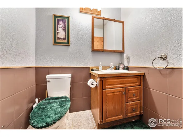 a living room with furniture a flat screen tv and a table