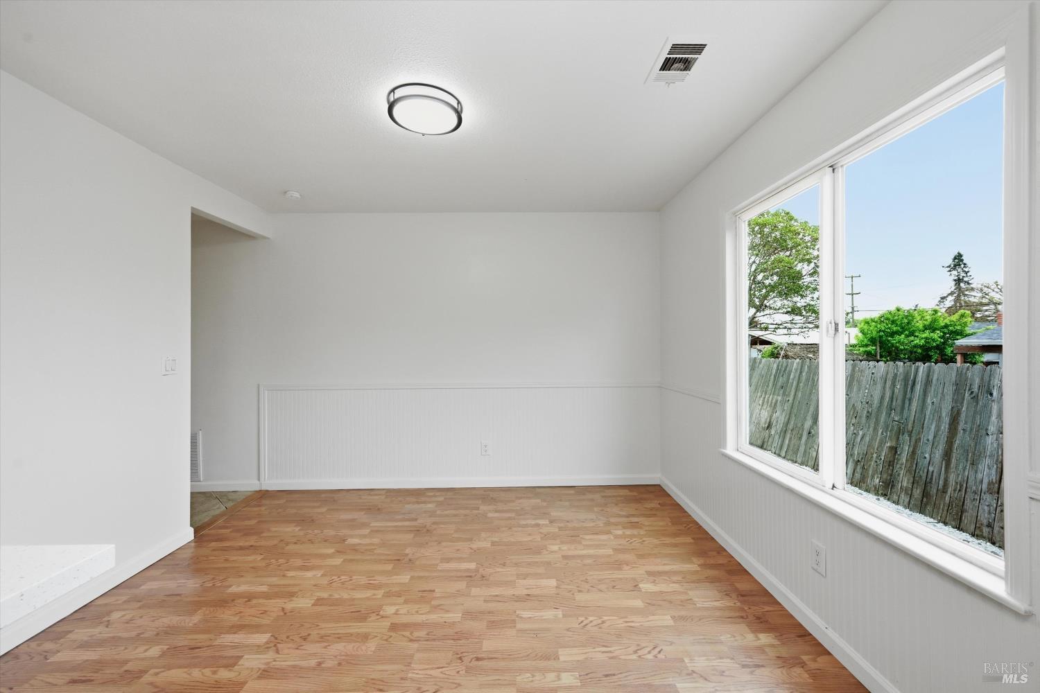 7930 Becky Court Rohnert Park, CA 94928 - Photo 17 of 33 a view of an empty room with wooden floor and a window