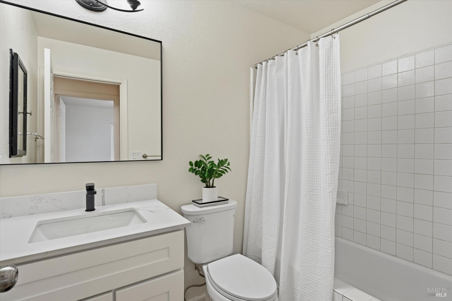 7930 Becky Court Rohnert Park, CA 94928 - Photo 19 of 33 a bathroom with a sink a toilet and shower curtain