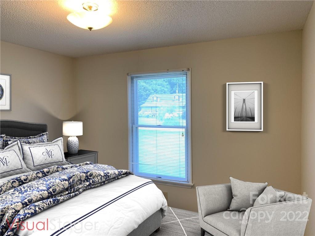 954 Old Charlotte Road Southwest Concord, NC 28027 - Photo 13 of 15 a bedroom with a bed and a couch