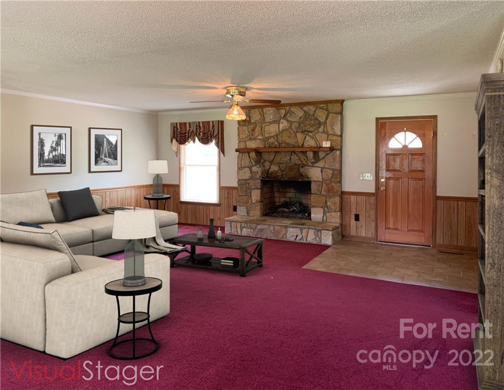 954 Old Charlotte Road Southwest Concord, NC 28027 - Photo 2 of 15 a living room with furniture and a fireplace