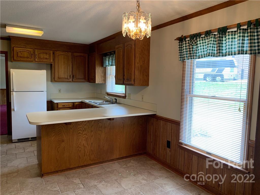 954 Old Charlotte Road Southwest Concord, NC 28027 - Photo 7 of 15 a kitchen with a sink and cabinets