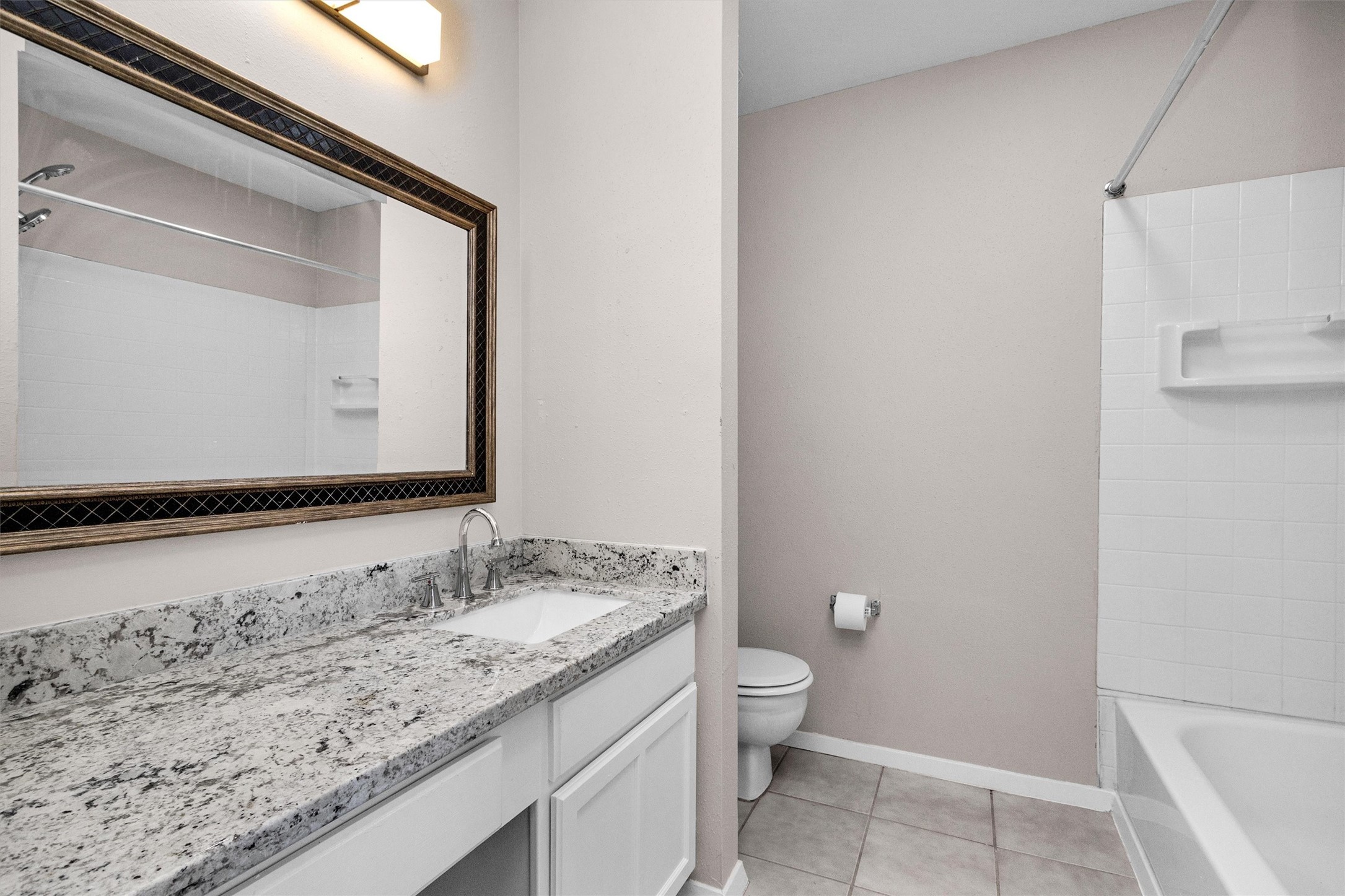 21030 Rivershadows Lane Spring, TX 77388 - Photo 16 of 38 a bathroom with a granite countertop sink and a mirror