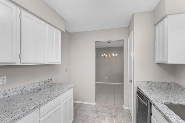 a kitchen with granite countertop a sink and a stove
