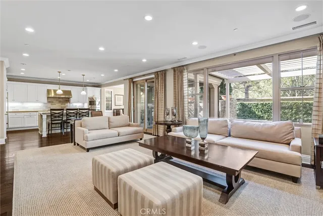 a living room with furniture and large windows