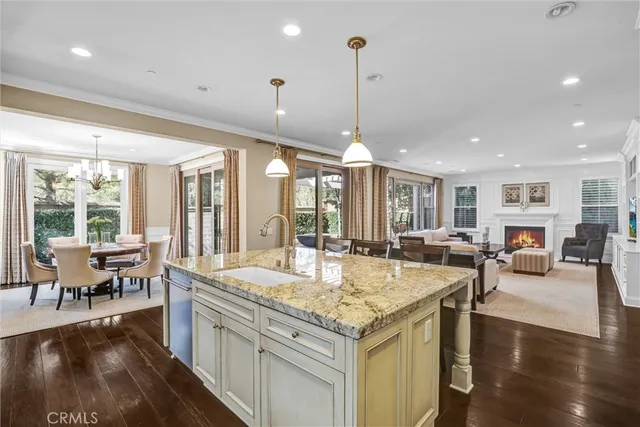 a view of living room with granite countertop kitchen island furniture and a wooden floor