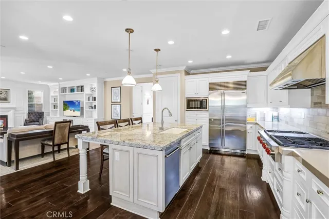 a kitchen with stainless steel appliances granite countertop a stove and a refrigerator