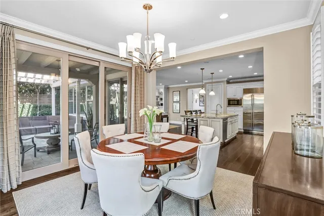 a view of a dining room with furniture wooden floor and chandelier