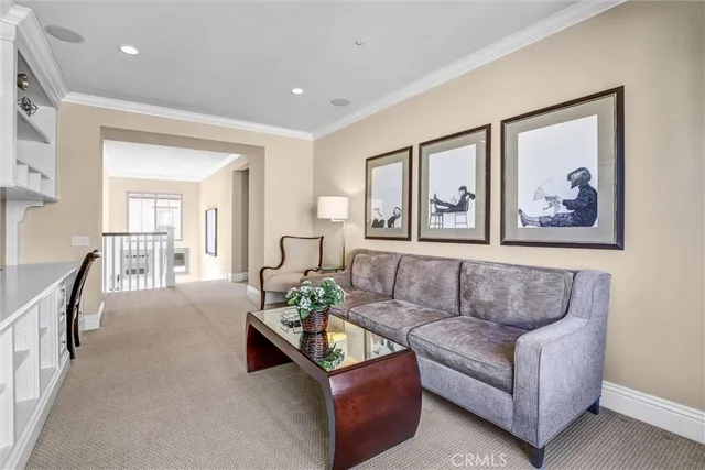 a living room with furniture and a painting on the wall