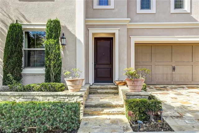a front view of a house with potted plants