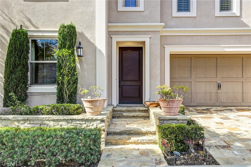 59 Rossmore Irvine, CA 92620 - Photo 2 of 45 a front view of a house with potted plants