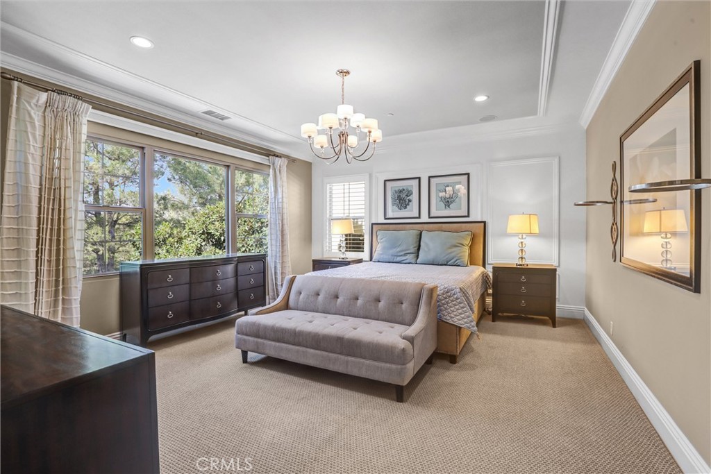 59 Rossmore Irvine, CA 92620 - Photo 21 of 45 a bedroom with a large bed and a chandelier