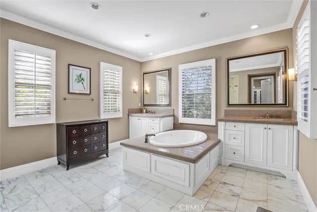 a spacious bathroom with a sink double vanity and a tub