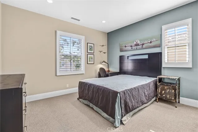 a bedroom with a bed dresser and a window