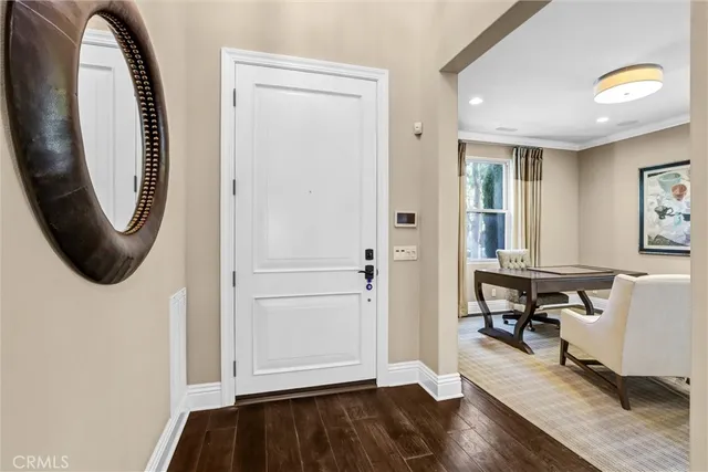 a view of entryway with wooden floor and livingroom view