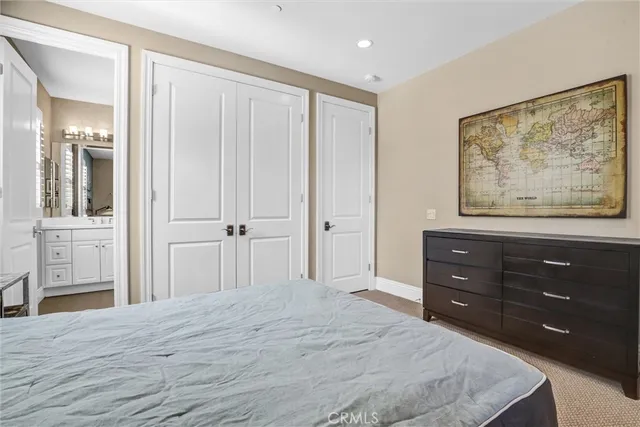 a bedroom with a bed and a mirror