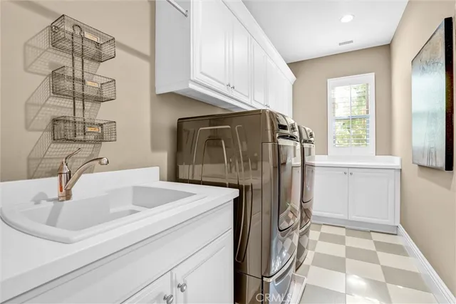 a kitchen with stainless steel appliances granite countertop a sink and a refrigerator