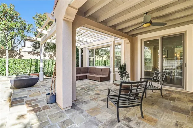 a building outdoor space with patio furniture and potted plants