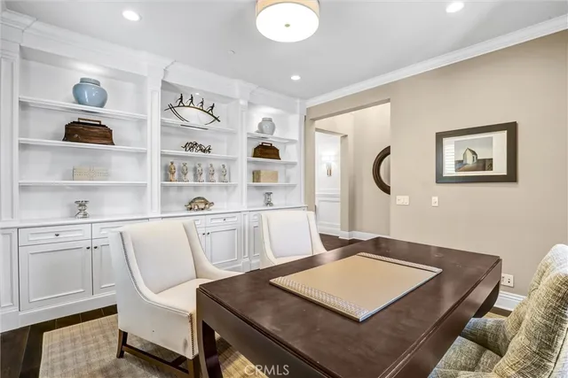 a living room with white furniture and a table