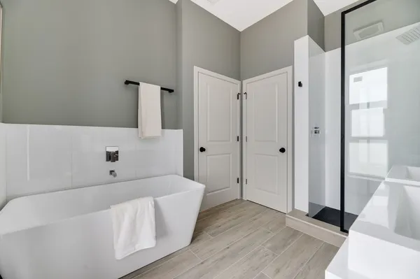 a bathroom with a bathtub and a walk in closet