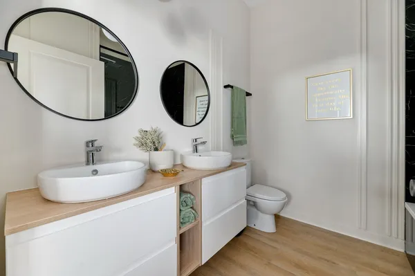 a bathroom with a toilet a sink and a mirror